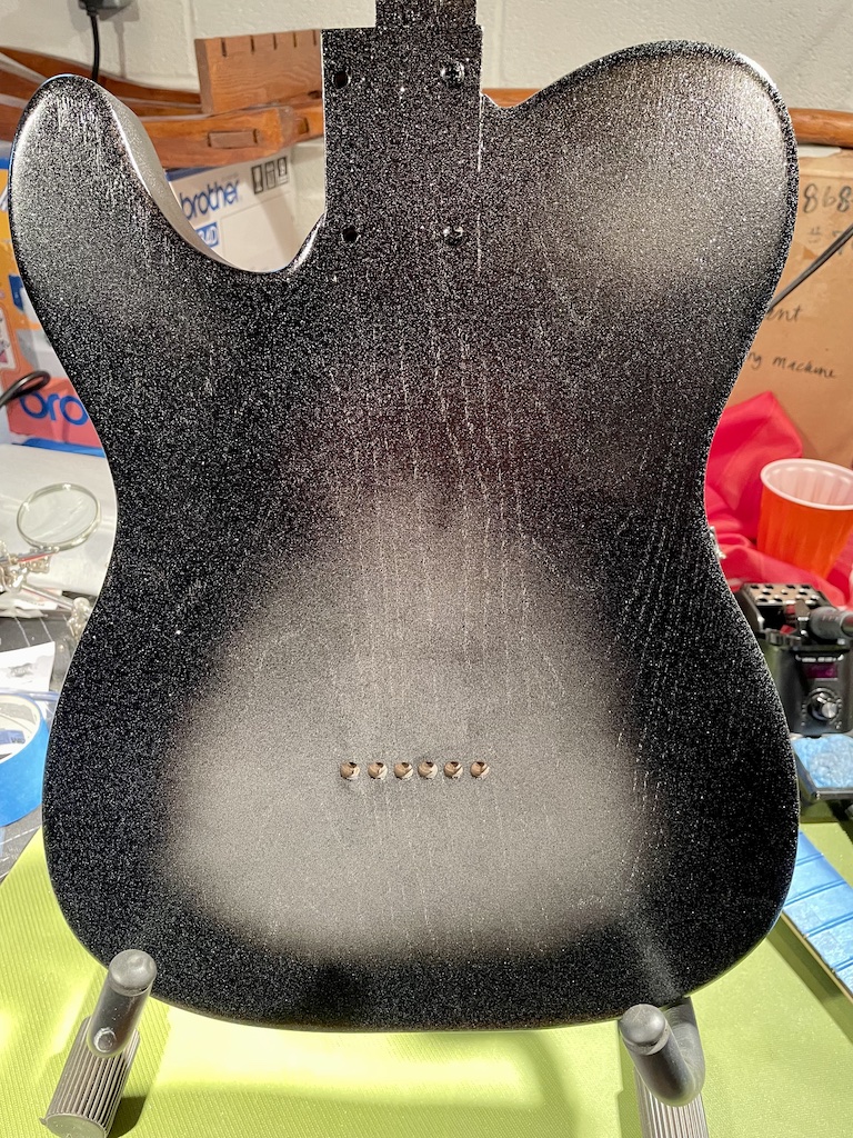 back of guitar body with black paint added