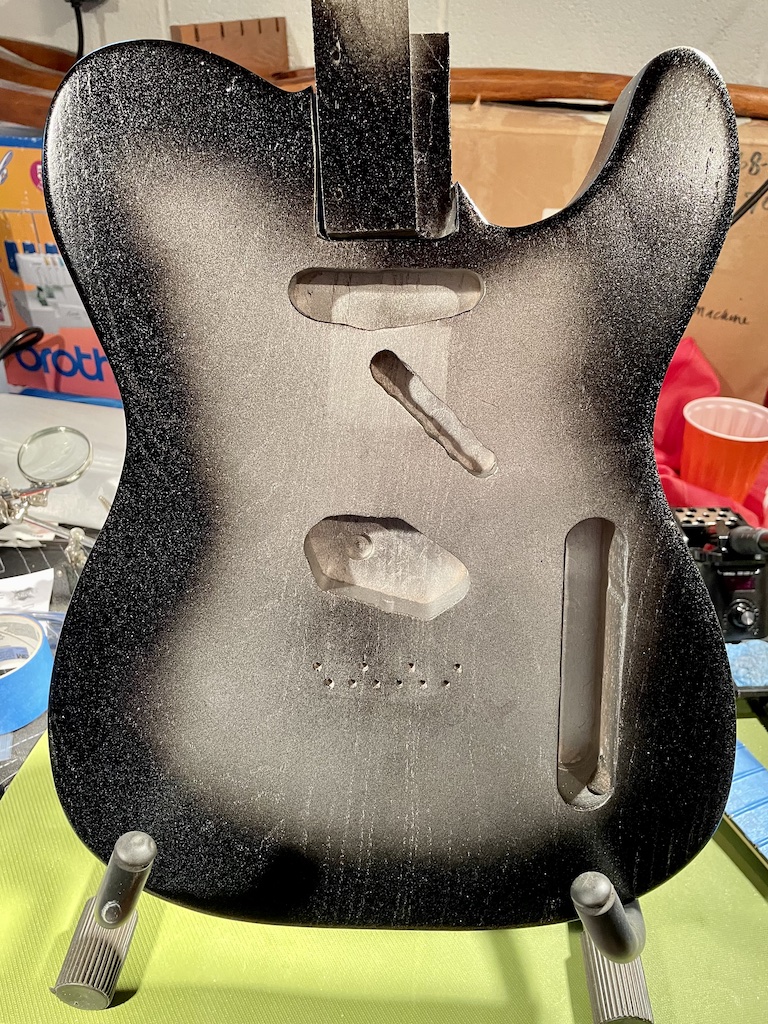front of guitar body with black paint added