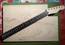 blank piece of swamp ash and a generic guitar neck