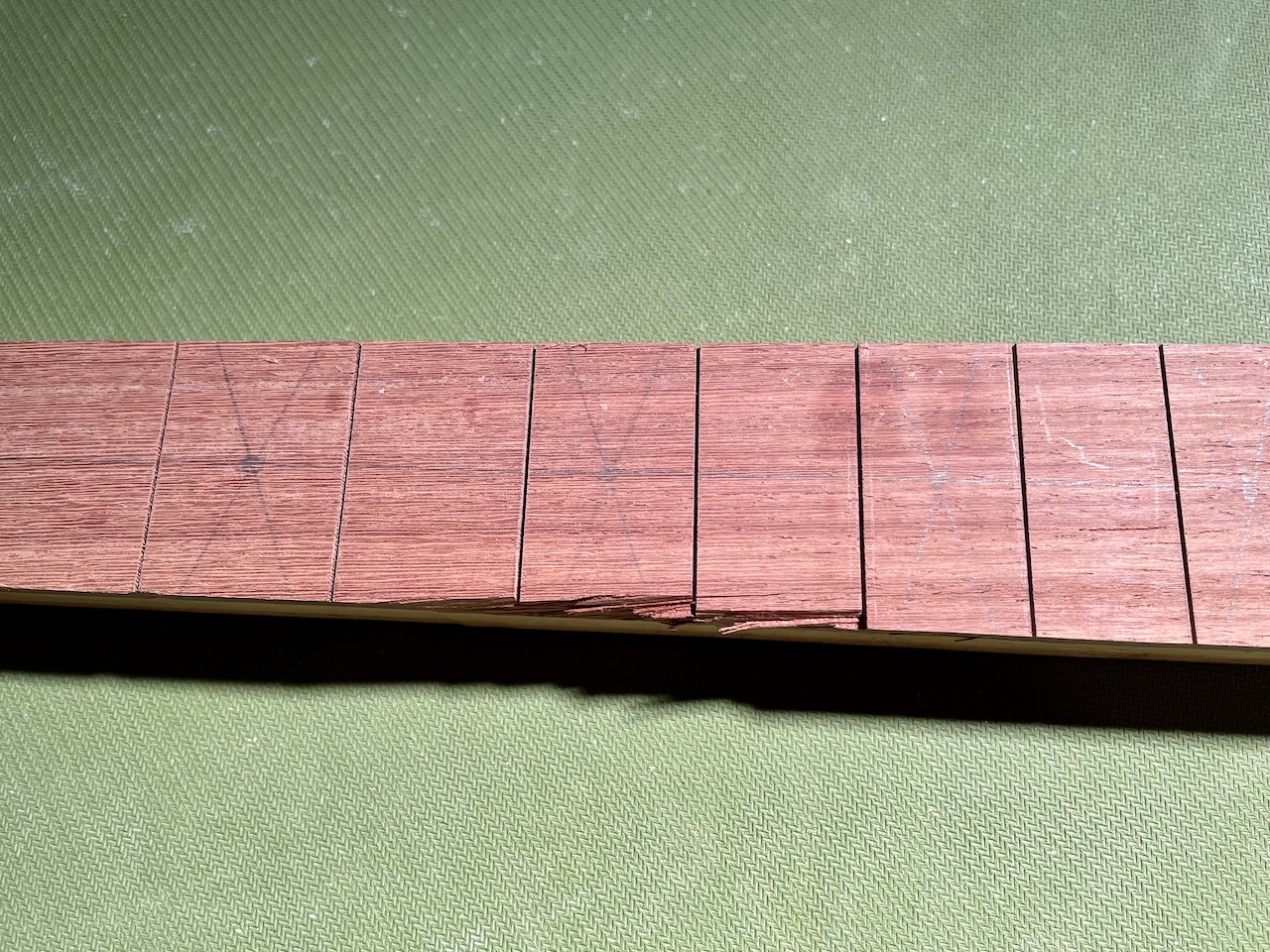 guitar neck with wood tear out from router